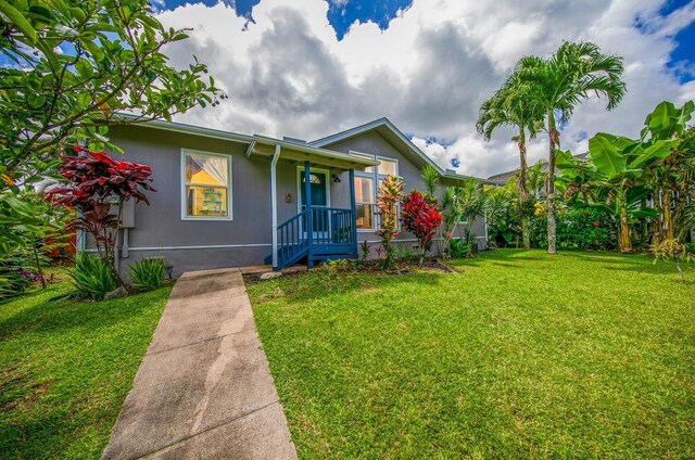 view of front of home featuring covered porch and a front yard