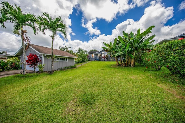 view of yard featuring driveway and an attached garage