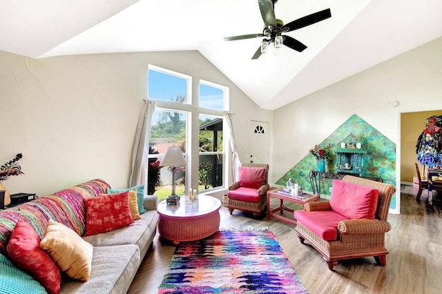 living area with high vaulted ceiling, wood finished floors, and a ceiling fan