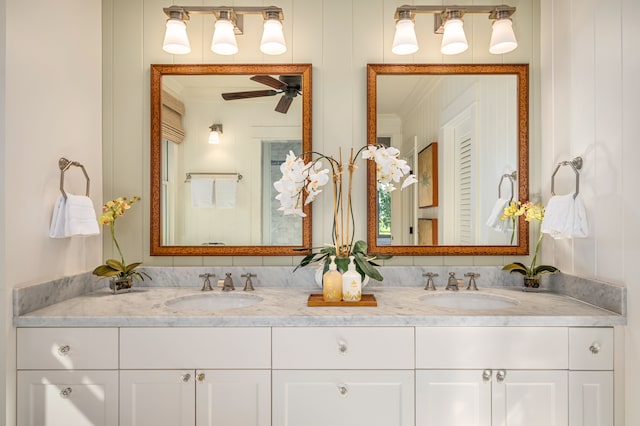 bathroom with ceiling fan, vanity, and ornamental molding