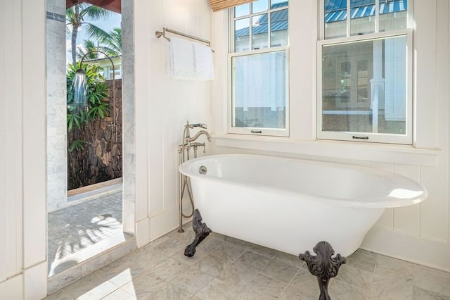 bathroom featuring a bath and tile patterned floors