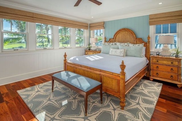 bedroom with ceiling fan, ornamental molding, and dark hardwood / wood-style floors