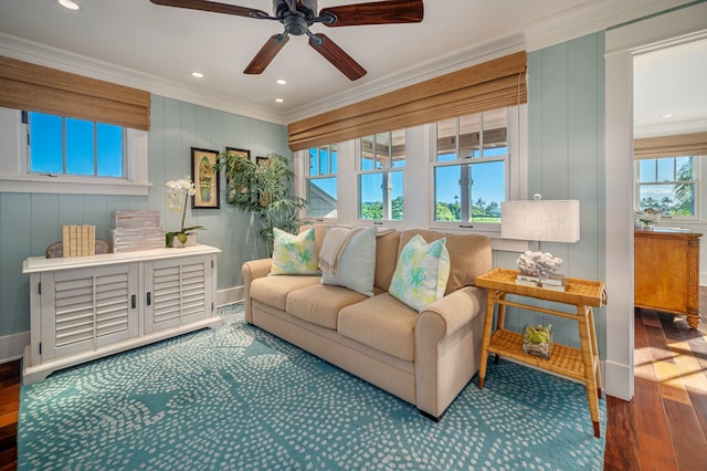 living room featuring ceiling fan, hardwood / wood-style flooring, and crown molding