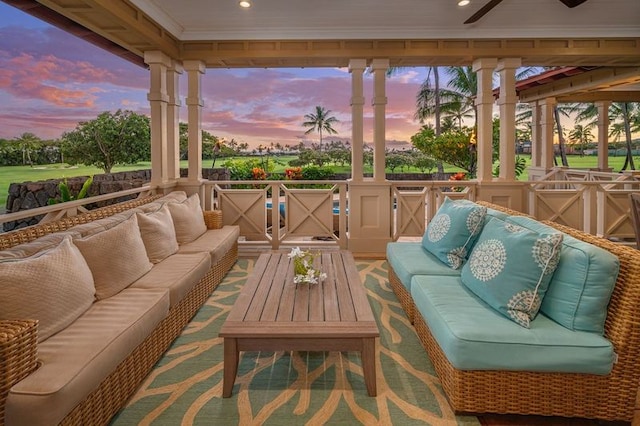 patio terrace at dusk featuring outdoor lounge area and a deck