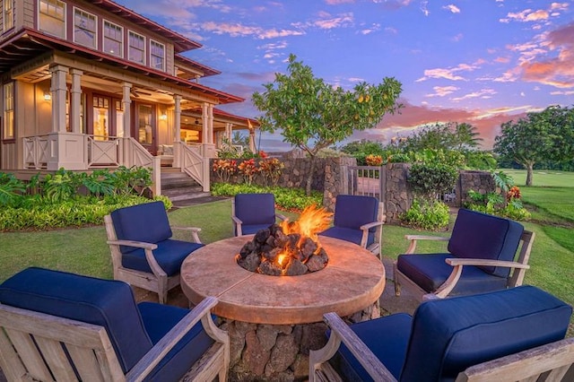 patio terrace at dusk featuring an outdoor fire pit