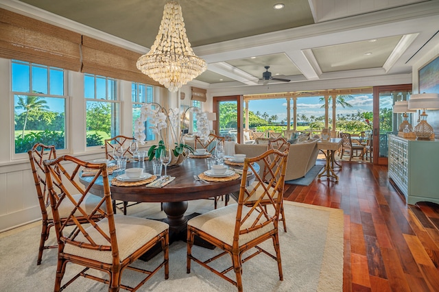 dining room with ceiling fan with notable chandelier, hardwood / wood-style floors, a healthy amount of sunlight, and coffered ceiling