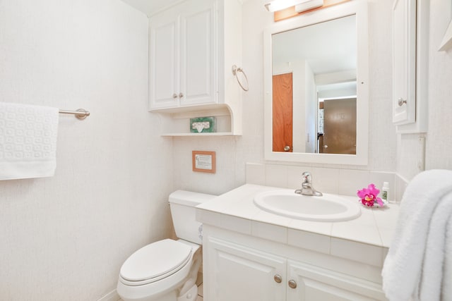 bathroom featuring toilet and vanity