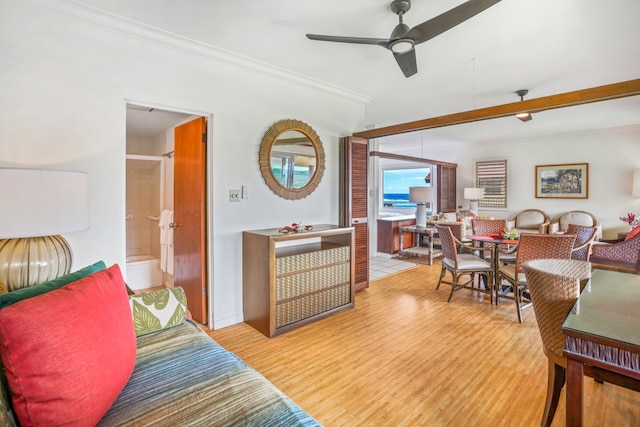 living room with ceiling fan, light hardwood / wood-style floors, and beam ceiling