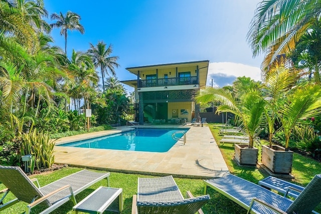 view of pool featuring a yard and a patio area