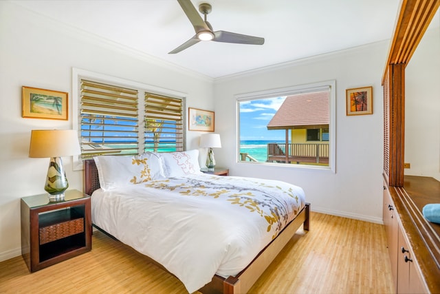 bedroom featuring ceiling fan, ornamental molding, and light wood-type flooring