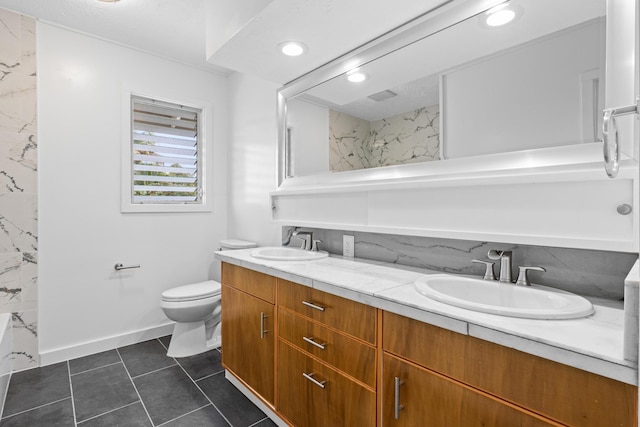 bathroom featuring vanity, tile patterned flooring, and toilet