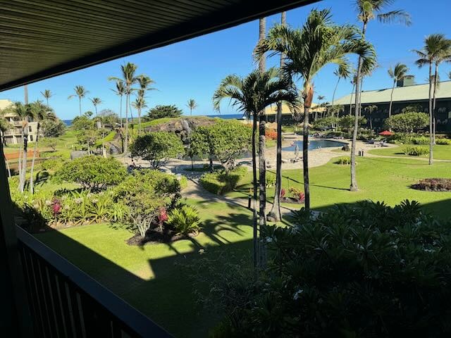 view of property's community with a yard and a pool