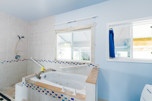 bathroom with independent shower and bath and a wealth of natural light