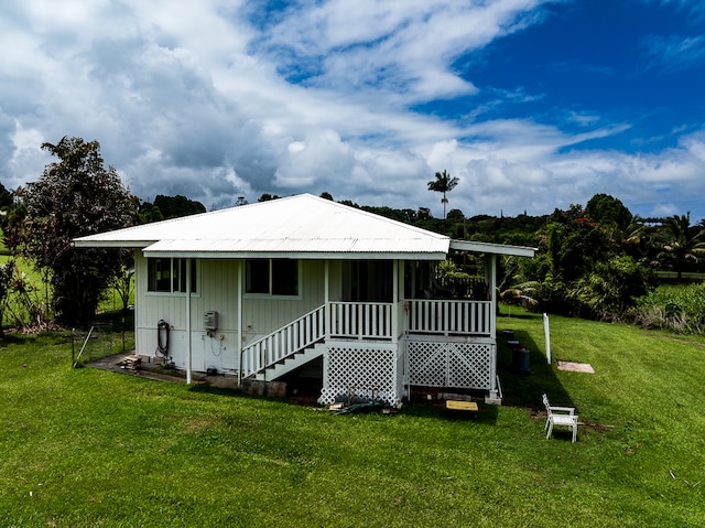 rear view of property with a lawn