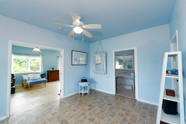 interior space with ceiling fan