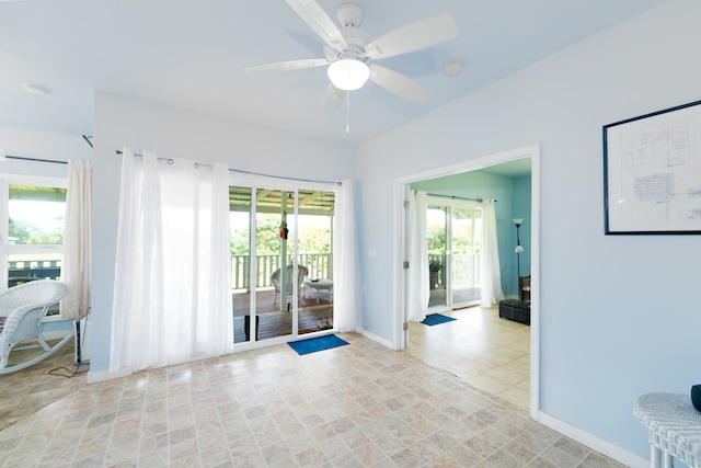 empty room featuring ceiling fan and light tile patterned floors