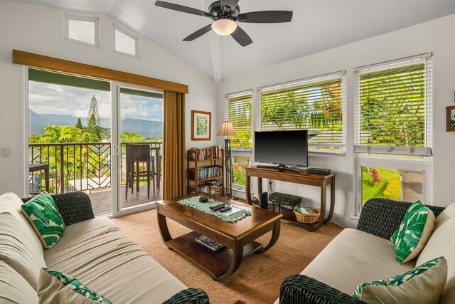 carpeted living room with lofted ceiling, ceiling fan, and a wealth of natural light