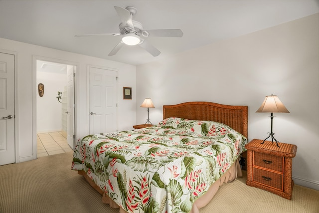 carpeted bedroom with ceiling fan and connected bathroom