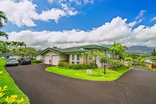 view of front of house featuring a garage and a mountain view