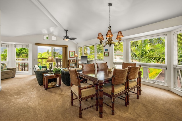 dining area with light carpet, ceiling fan with notable chandelier, lofted ceiling with beams, and a healthy amount of sunlight