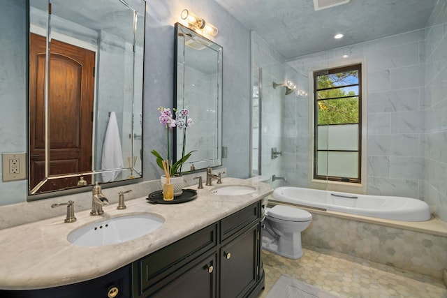 full bathroom with tiled shower / bath combo, vanity, toilet, and tile patterned flooring