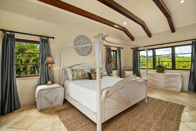 bedroom with lofted ceiling with beams, baseboards, stone tile floors, and multiple windows