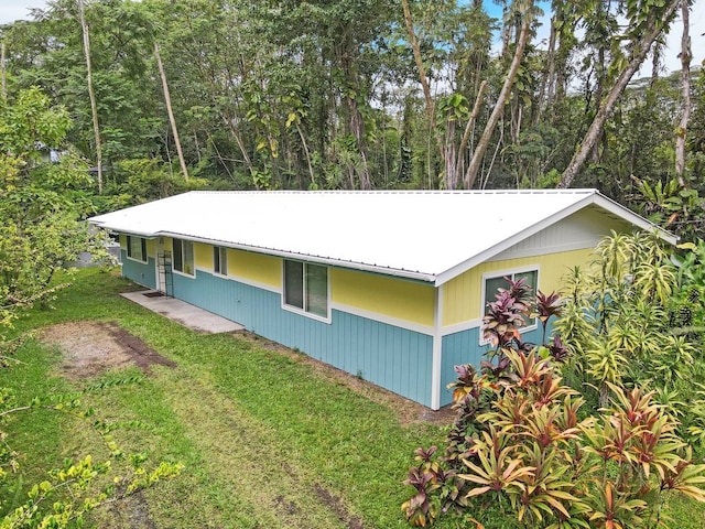 view of side of property with a lawn