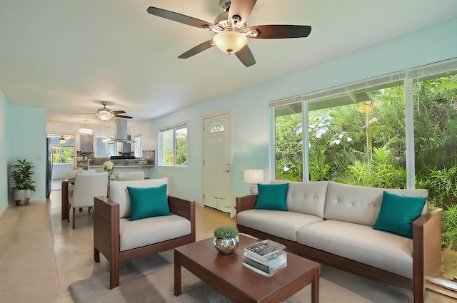 tiled living room with ceiling fan and a healthy amount of sunlight