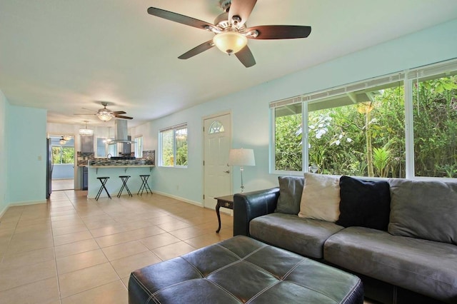 tiled living room featuring a wealth of natural light and ceiling fan