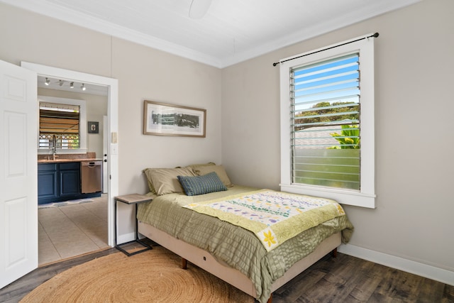 bedroom featuring sink, crown molding, connected bathroom, and dark hardwood / wood-style floors