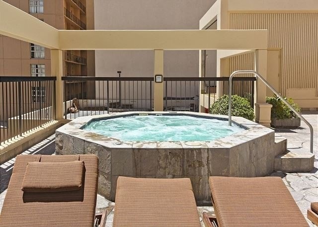 view of swimming pool featuring an in ground hot tub