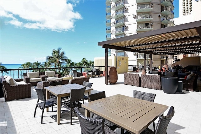 view of patio with a balcony, an outdoor hangout area, and a water view