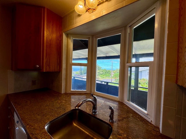 kitchen featuring dark stone counters and sink