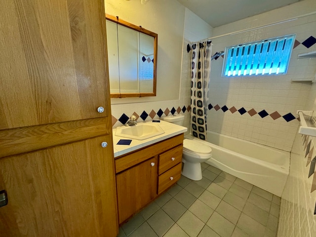 full bathroom with tile walls, shower / bath combo, tile patterned floors, vanity, and toilet