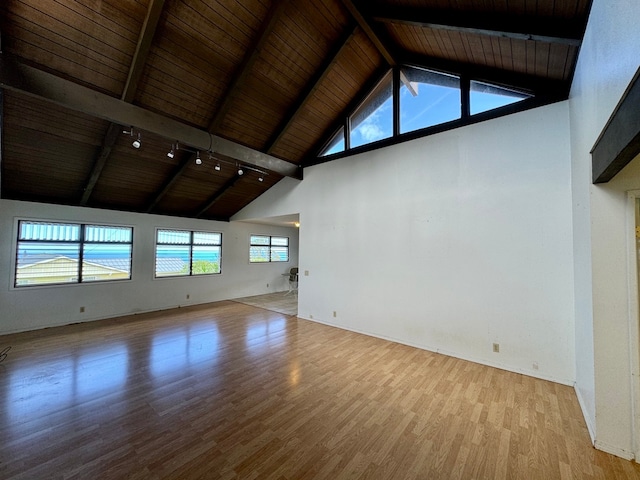 unfurnished living room with light wood-type flooring, wood ceiling, beamed ceiling, and high vaulted ceiling