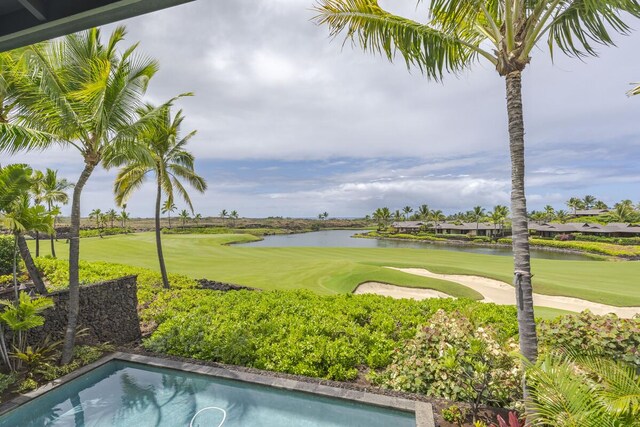 exterior space with golf course view and a water view