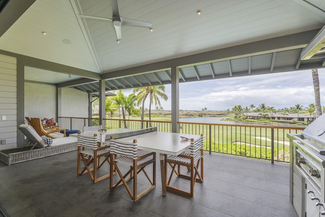 view of patio / terrace featuring outdoor dining area, a ceiling fan, and a water view