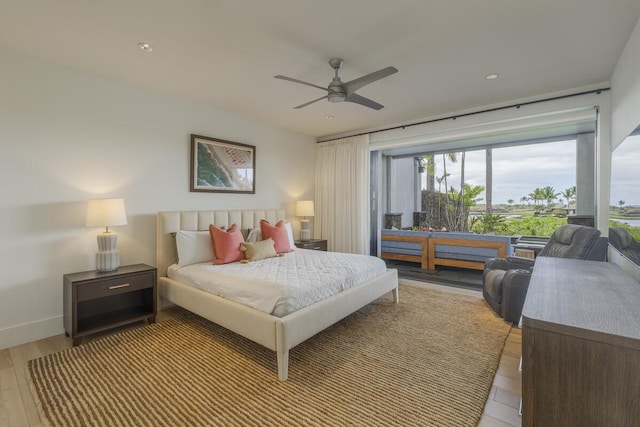 bedroom with a ceiling fan, light wood-style floors, and baseboards