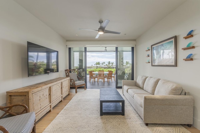 living area with ceiling fan and light wood finished floors