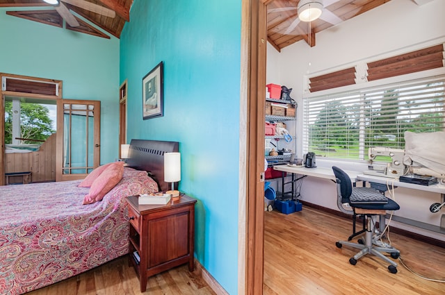 bedroom with light hardwood / wood-style floors, wood ceiling, lofted ceiling with beams, and ceiling fan