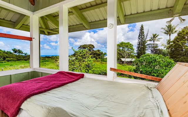 bedroom featuring multiple windows and beam ceiling