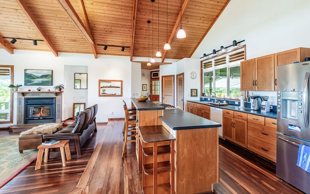 kitchen featuring dark hardwood / wood-style flooring, high vaulted ceiling, wooden ceiling, stainless steel appliances, and a center island