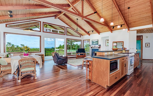 kitchen with dark wood-type flooring, wooden ceiling, stainless steel microwave, and white range with gas stovetop