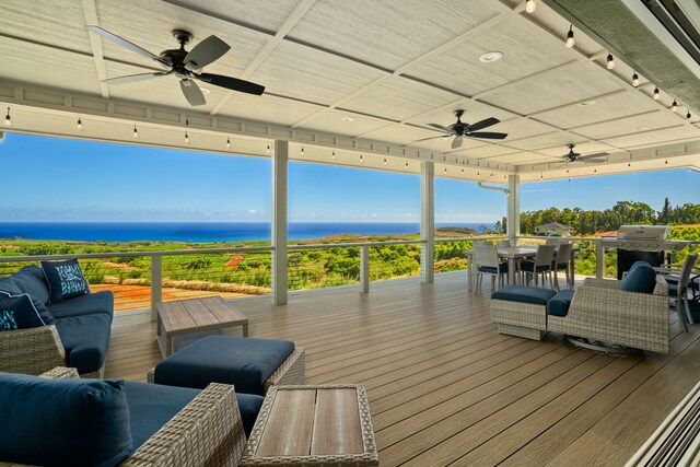 wooden terrace with a water view, ceiling fan, and a grill