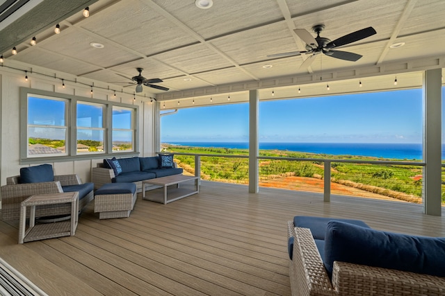 wooden terrace featuring an outdoor hangout area, a water view, and ceiling fan