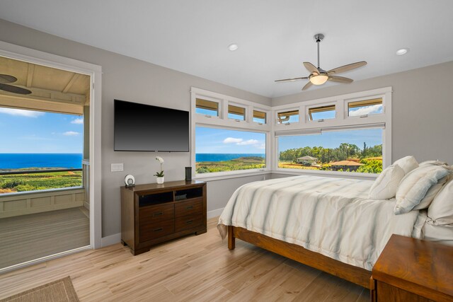 bedroom featuring light wood-type flooring, multiple windows, and ceiling fan