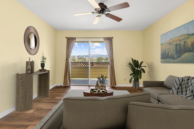 living room with hardwood / wood-style floors and ceiling fan