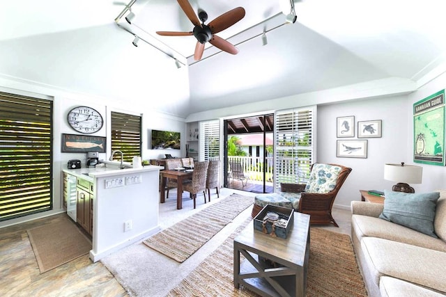 living room with ceiling fan, track lighting, sink, and high vaulted ceiling