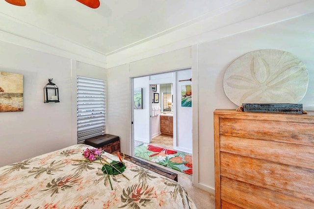 carpeted bedroom featuring connected bathroom and ceiling fan