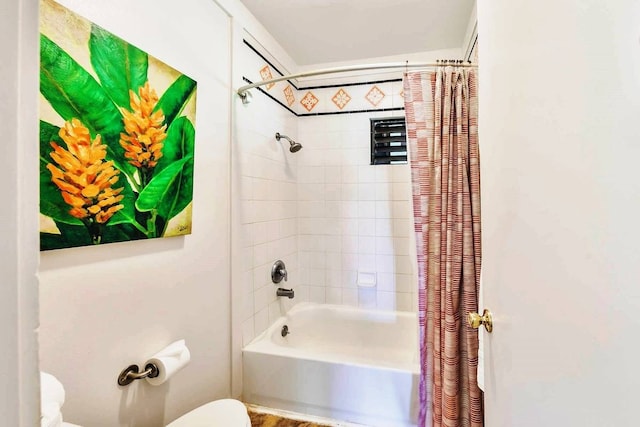 bathroom with shower / bathtub combination with curtain and toilet